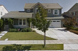 A two-story house with a garage and driveway.