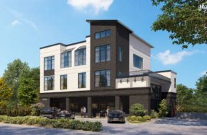 Modern brick building with storefront and parking lot.